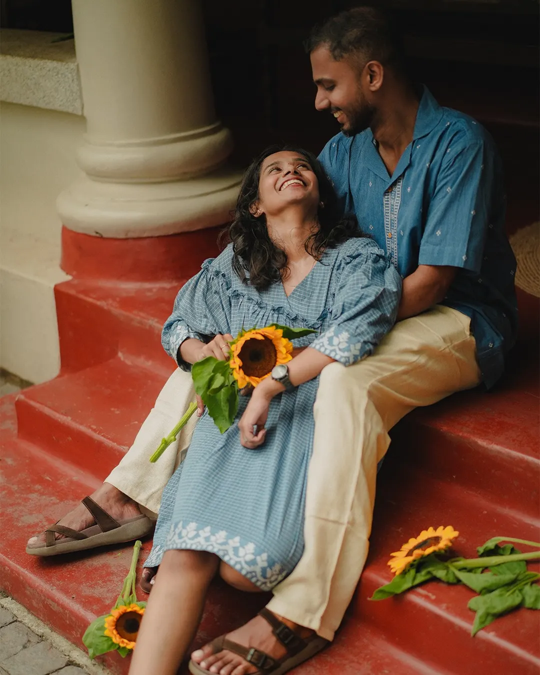 Couple sharing a relaxed portrait on red steps