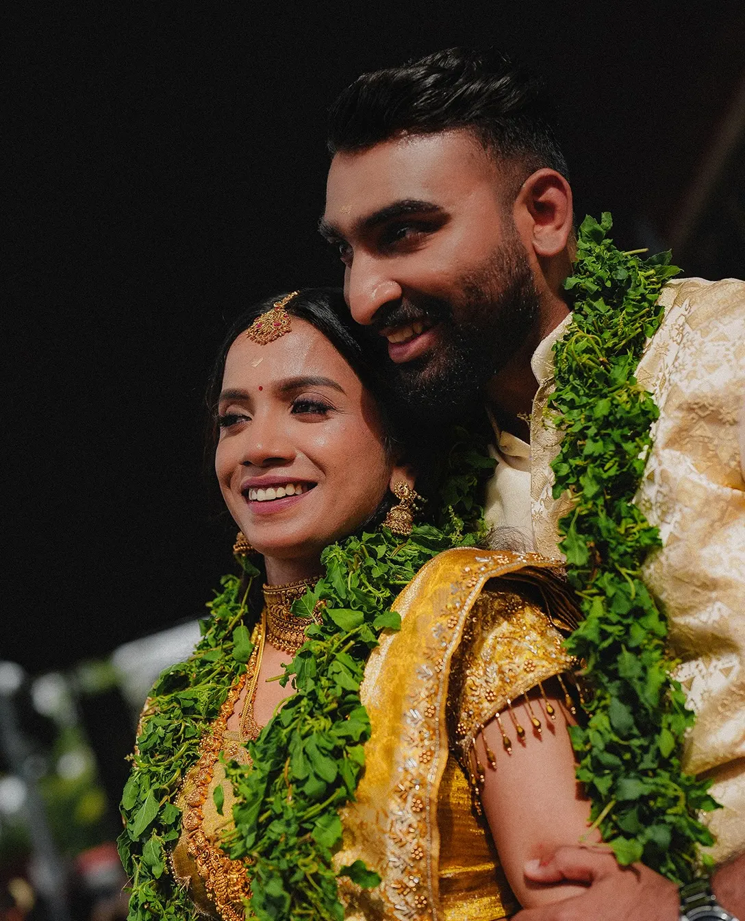 Kerala bride and groom wearing fresh green garlands